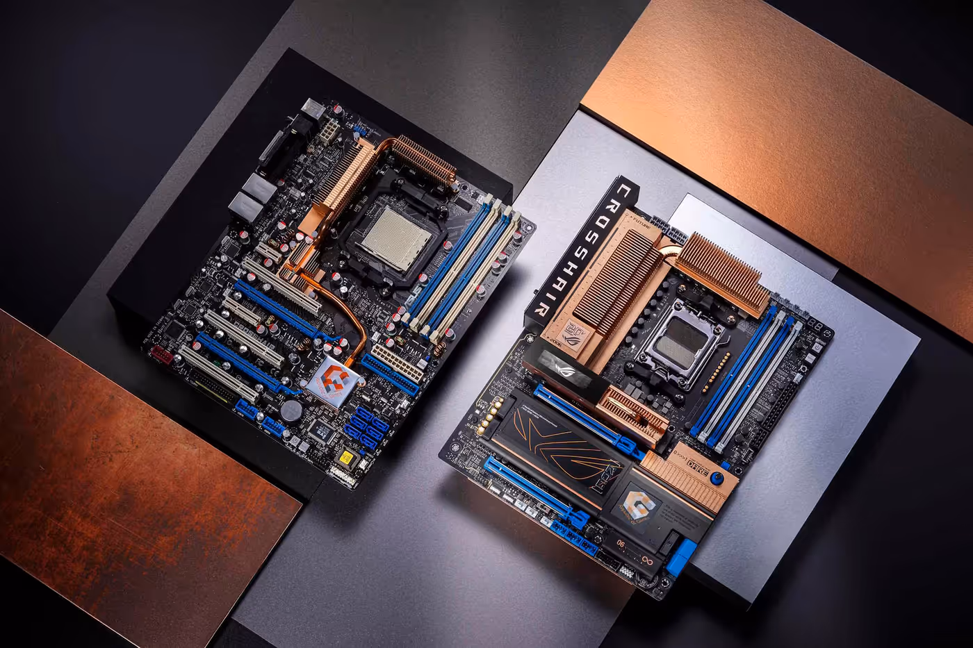 Two ROG Crosshair motherboards laid flat on a table and viewed from an overhead angle