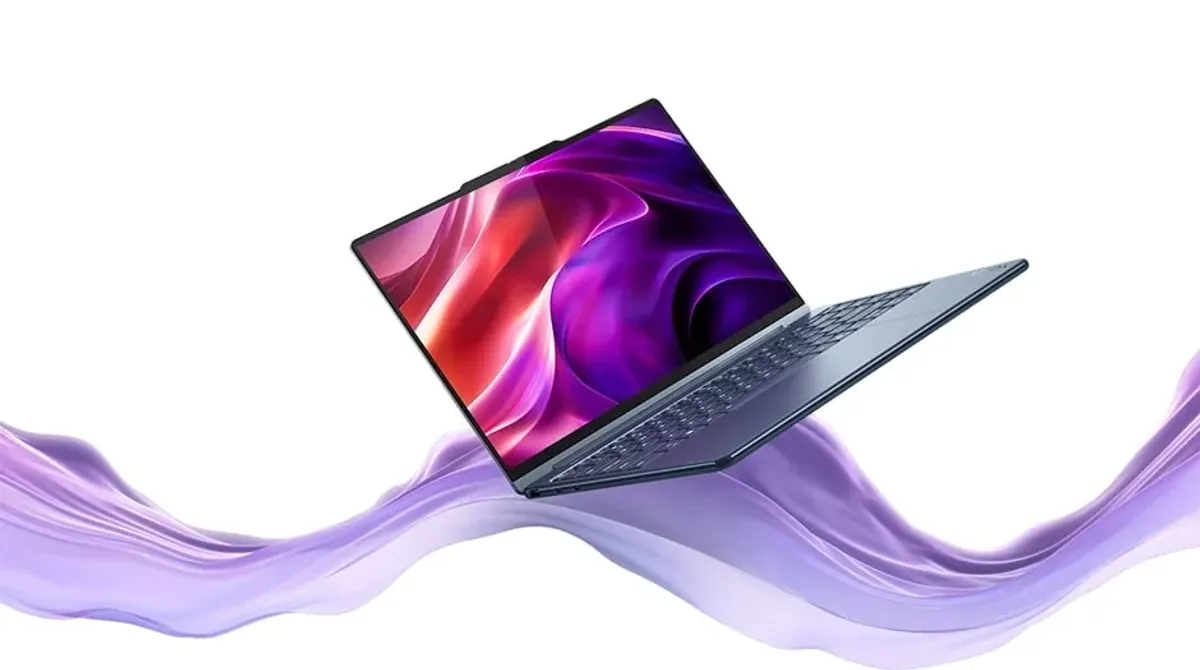 A swirling lavender ribbon supports an opened Yoga 9i 2-in-1 Gen 10 Aura Edition (14 Intel).