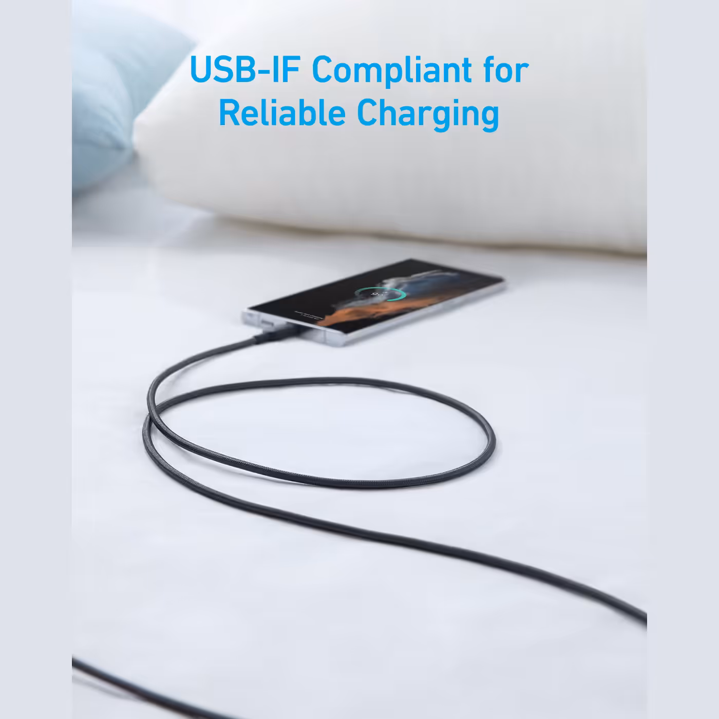 Anker 322 cable charging a phone on a bed