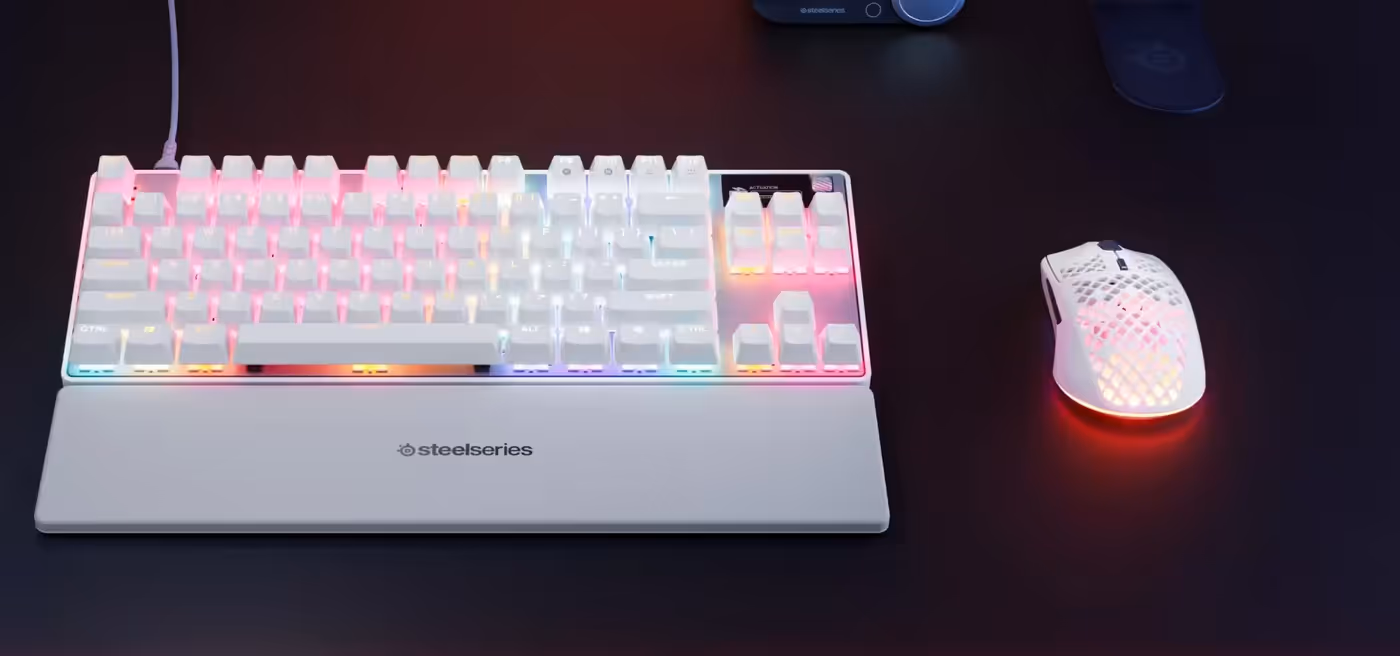 Keyboard and mouse illuminated with colorful, dynamic Per-Key RGB lighting effects synchronized via Prism software.