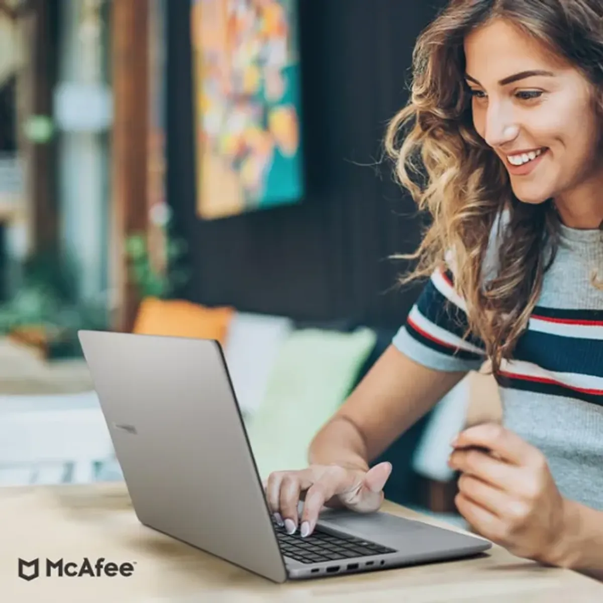 Laptop interface showcasing McAfee Smart AI cyber security and data protection features