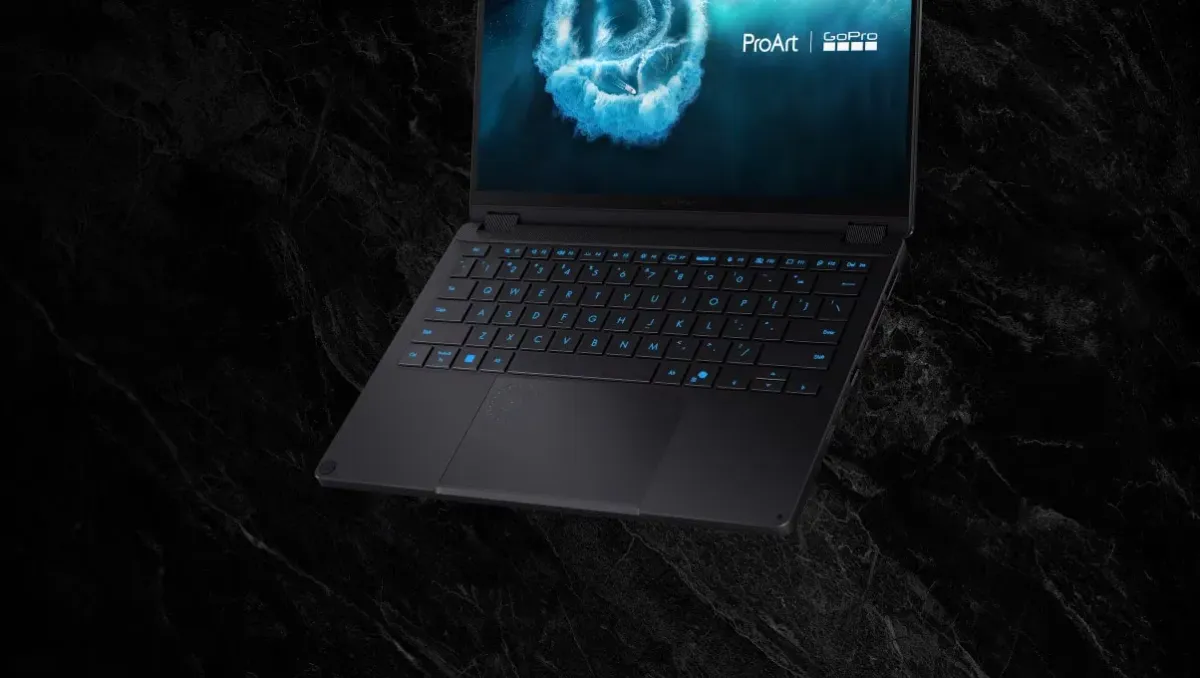 Laptop keyboard with signature cyan backlighting in a dark setting