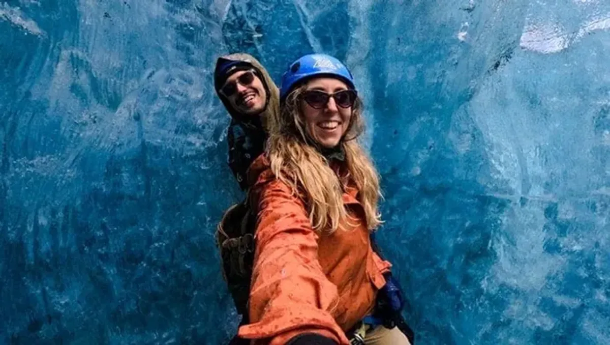 People capturing adventure memories with GoPro in an ice cave