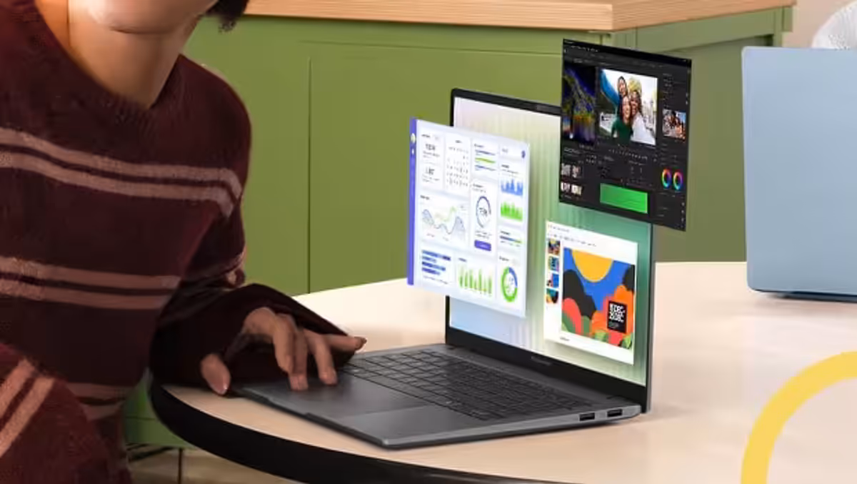 A Matte Gray ASUS Vivobook S14 placed on a table with three windows pop up from the screen.