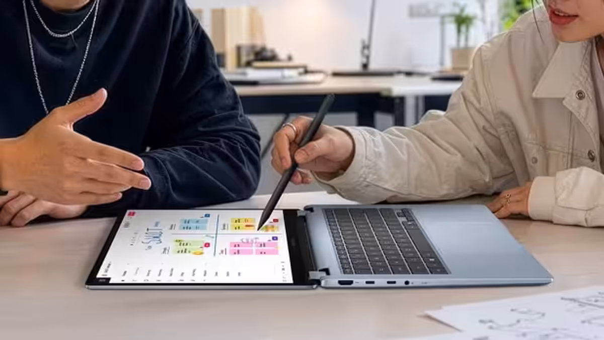 Two people sharing content using the ASUS Vivobook S14 in 180° sharing mode.