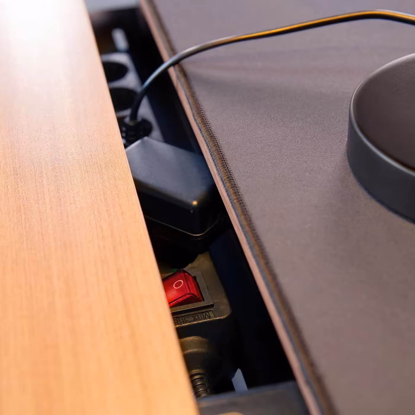 Hidden metal cable management baskets underneath desk for organized cable storage