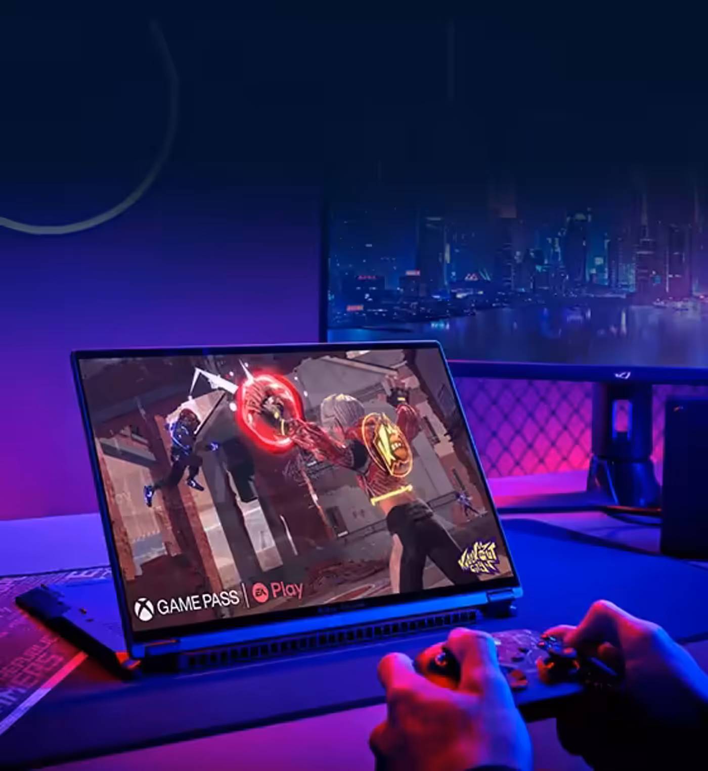 Hands holding a game controller with a laptop displaying gameplay footage.