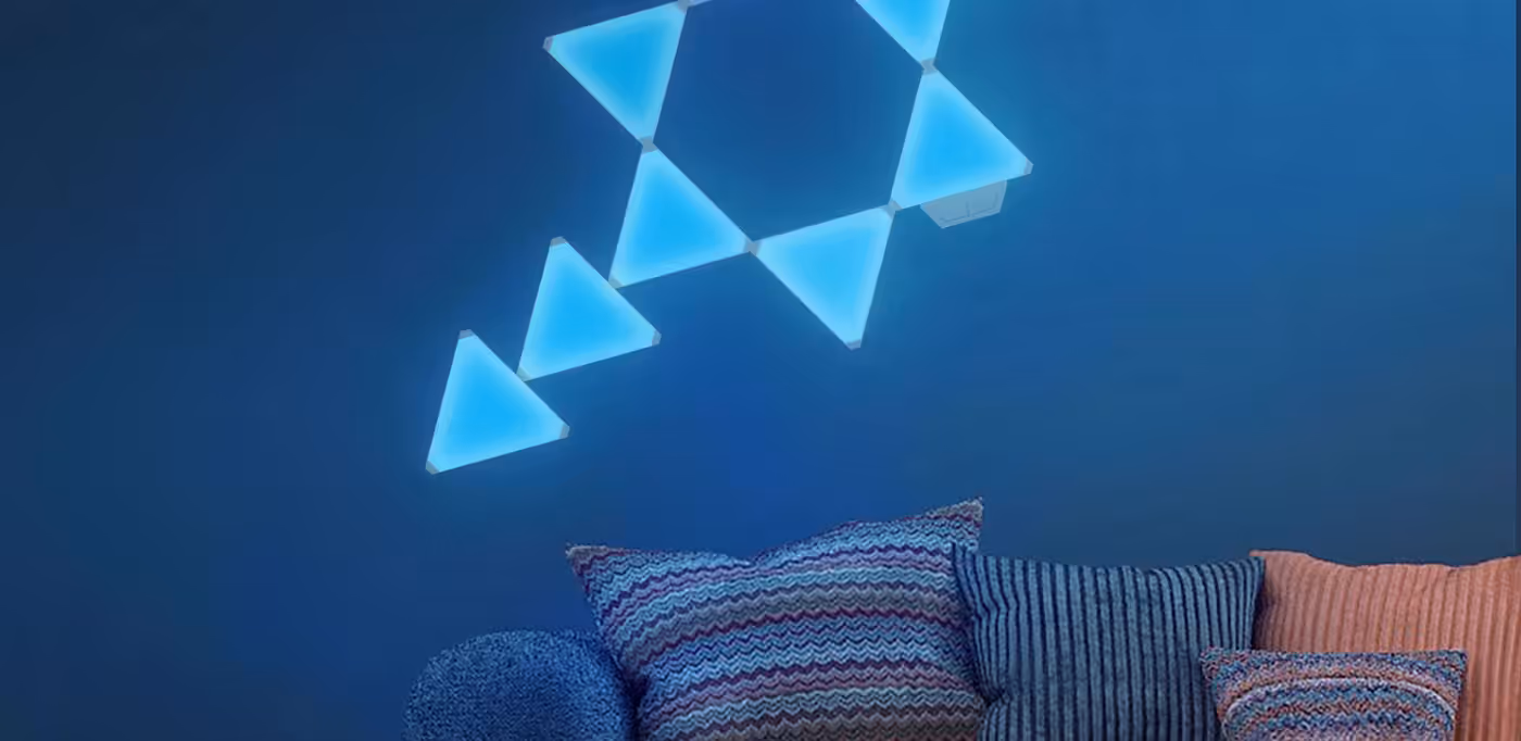 Cololight Triangle Extension Kit panels lighting a room wall