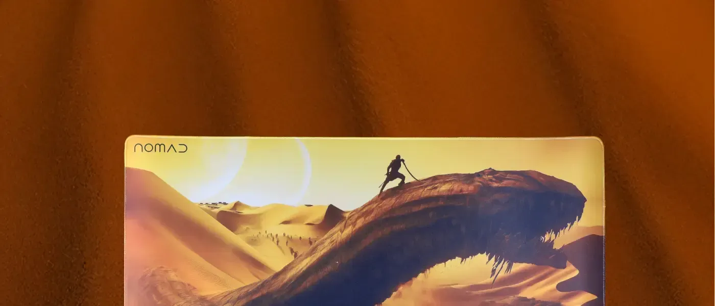 Evetech Nomad mousepad in warm orange tones beneath a gaming setup