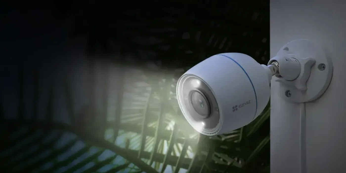 EZVIZ C3TN outdoor security camera mounted on a wall with night vision active