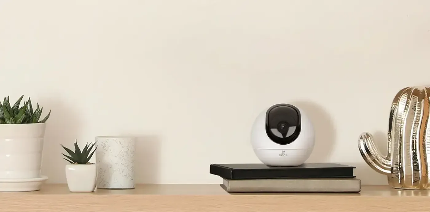 EZVIZ C6 4MP indoor pan and tilt camera viewed alongside its mobile app
