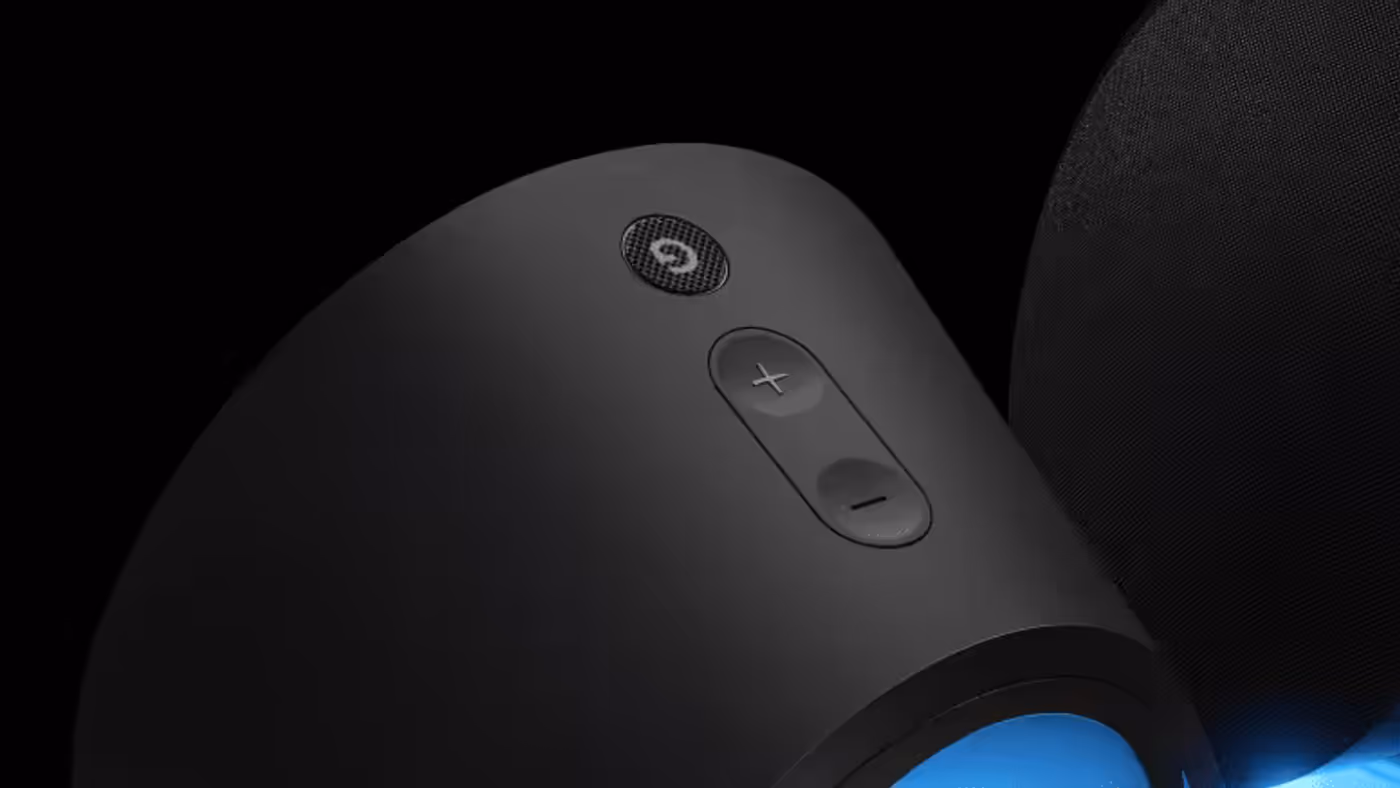 Close-up of speaker physical control buttons and volume knob