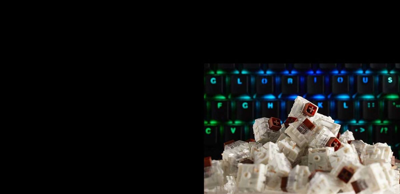Kailh Brown tactile switches laid out on a desk beside a mechanical keyboard