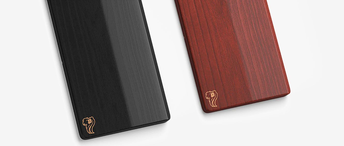 Side view of the 19mm thick Glorious wooden wrist rest next to a keyboard