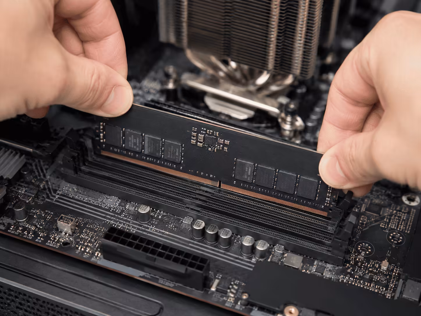 Hands installing RAM