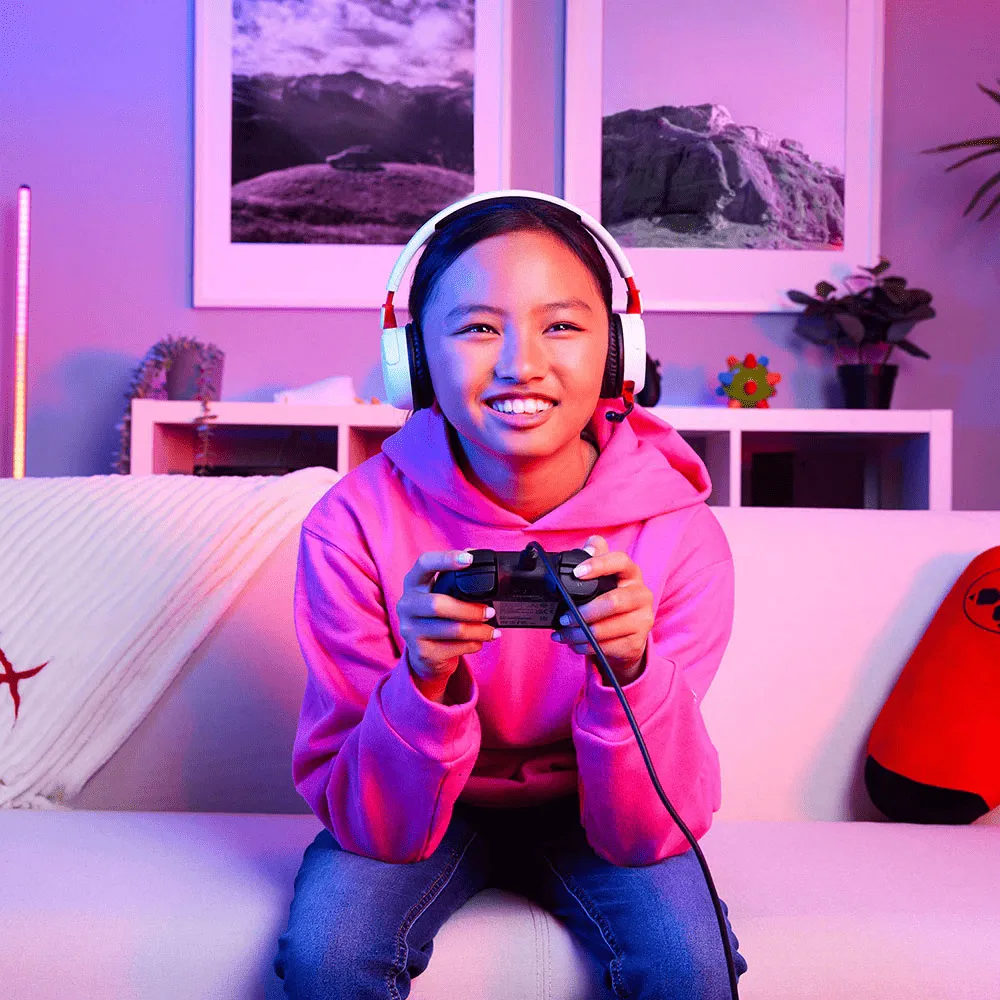 Young gamer using HyperX Cloud Mini Wireless Gaming Headset for immersive audio