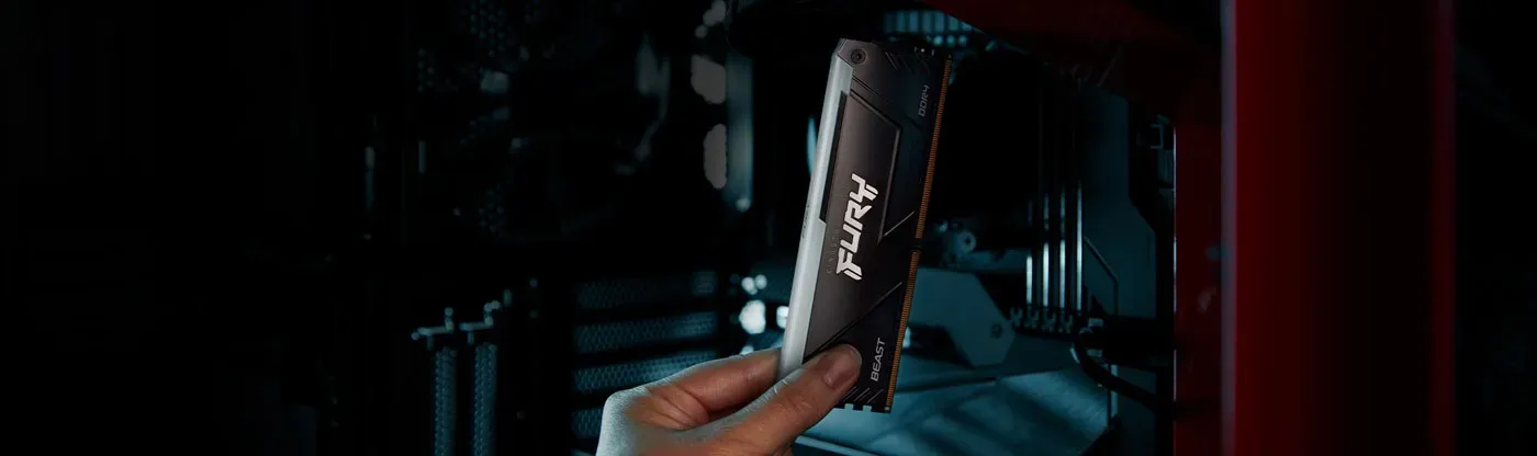 Kingston FURY Beast RGB DDR4 modules being fitted into a desktop motherboard