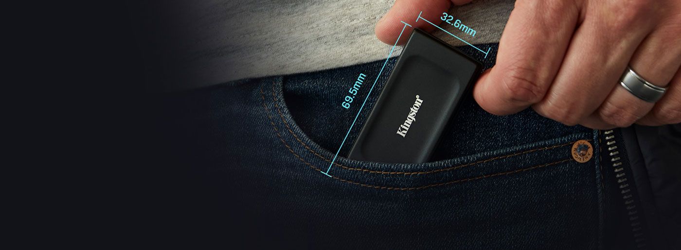 Kingston XS1000 portable SSD held in one hand to show its compact all-black body