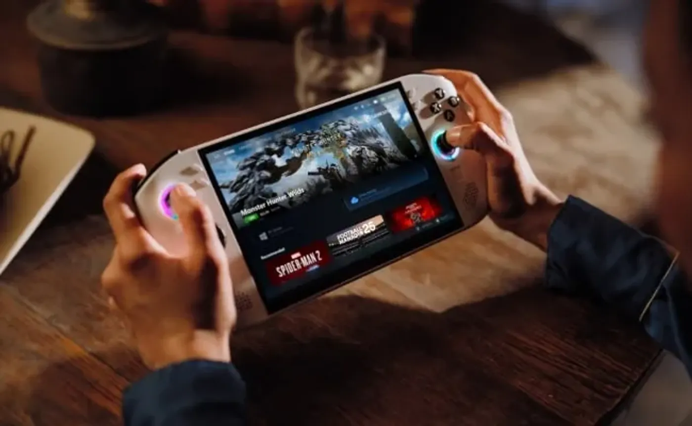 Hands using a Legion Go S on a table in a bar playing a Monster game