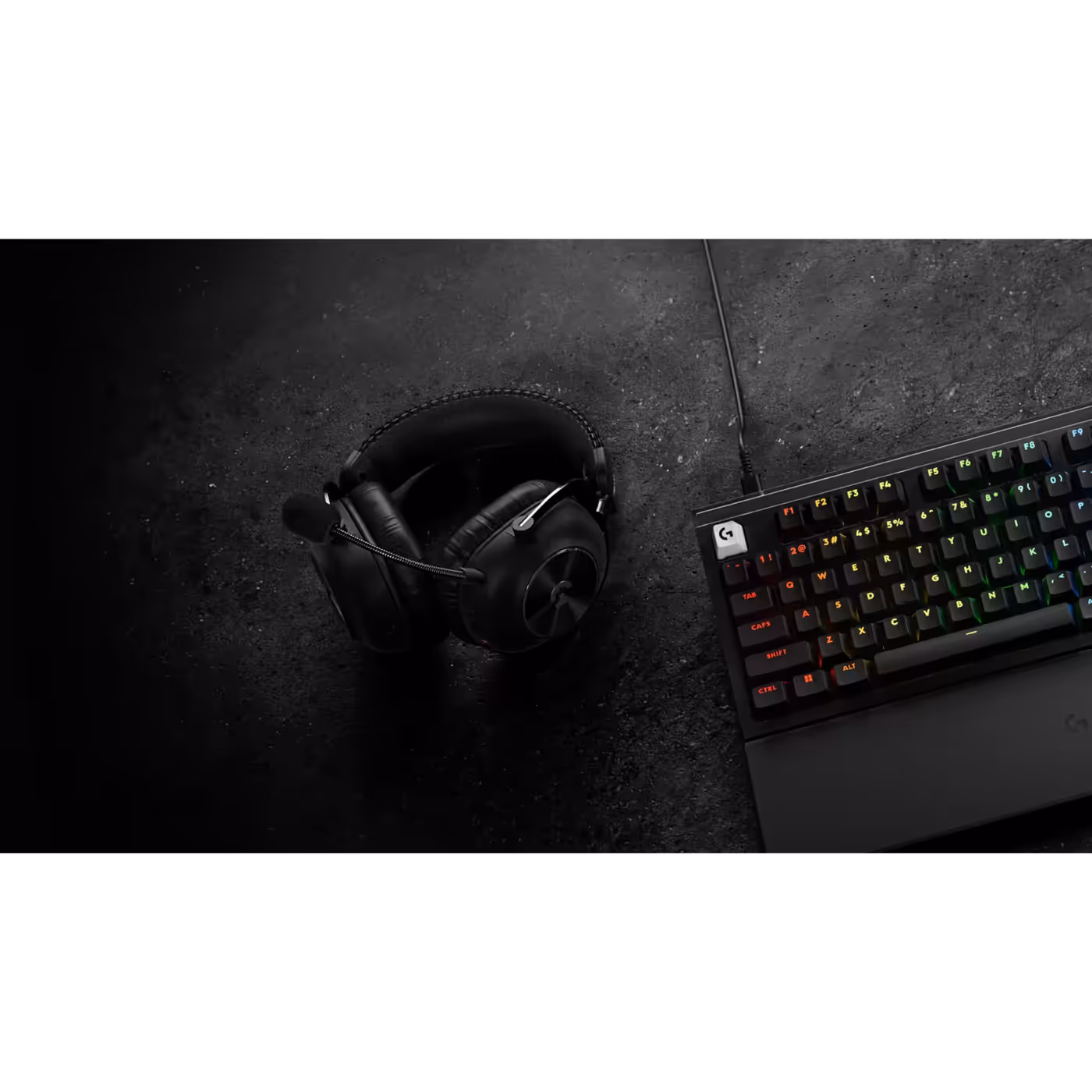 PRO X3 LIGHTSPEED in black on a desk next to a keyboard