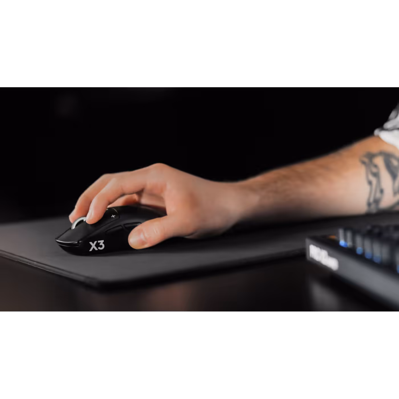 Hand on the PRO X3 SUPERSTRIKE on a mouse pad