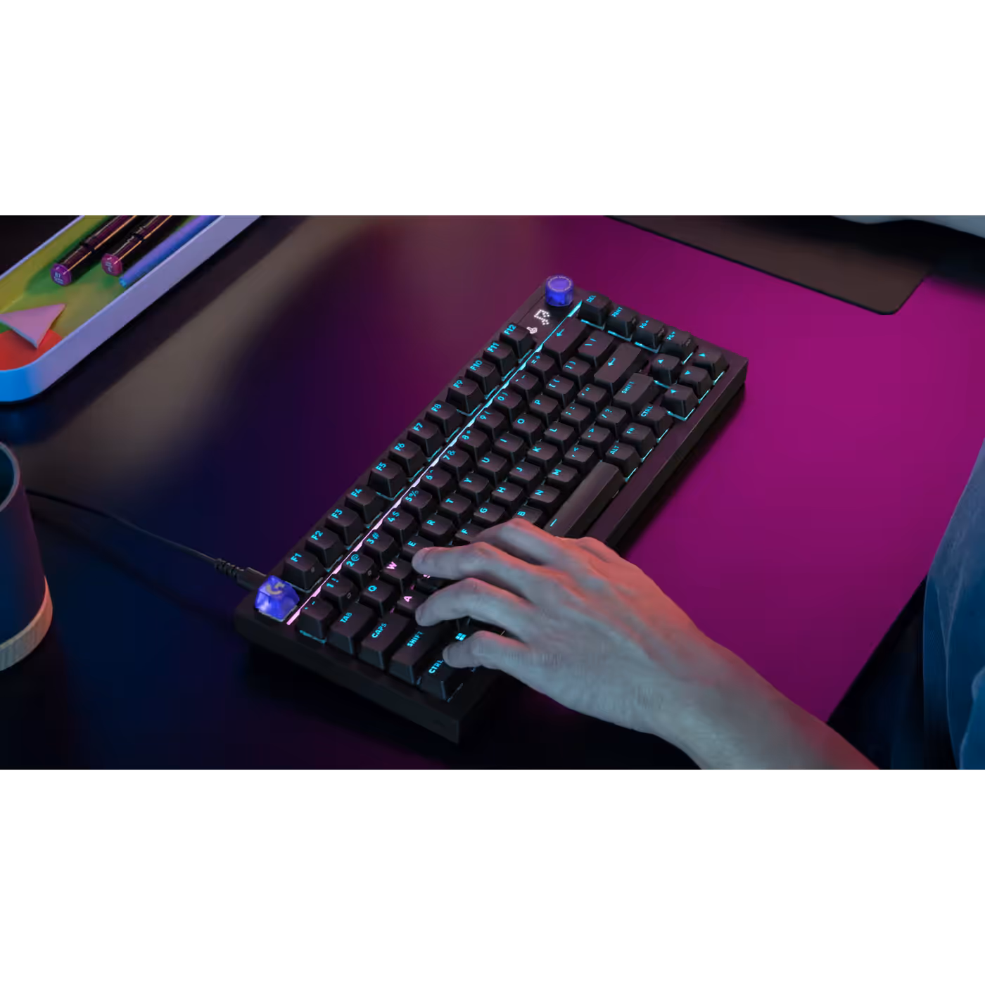 Black G316 X 75 on a desk with a hand on the keys