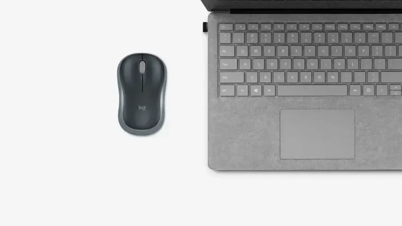 Logitech M185 wireless mouse used alongside a laptop for daily work