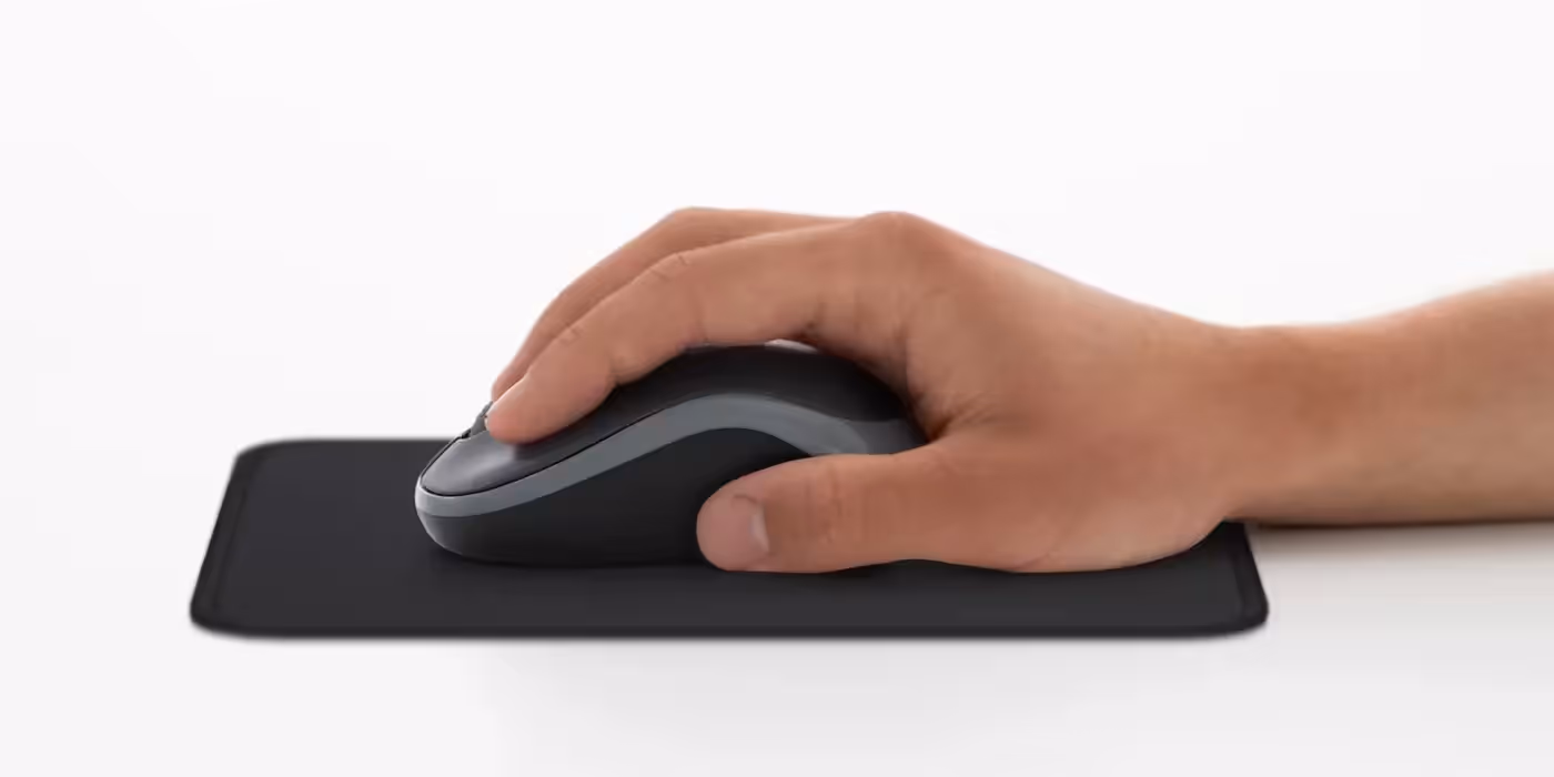 Close-up of the blue Logitech M185 wireless mouse showing its compact contoured shape
