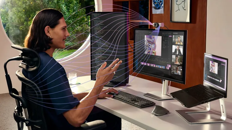Logitech MX Brio webcam highlighting dual beamforming noise-reducing microphones