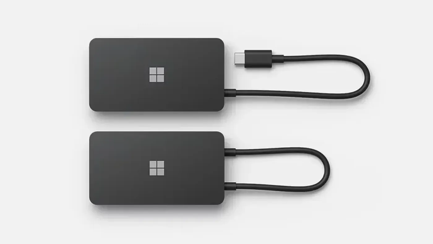 Microsoft Surface USB-C Travel Hub shown alongside a USB-C equipped Surface laptop