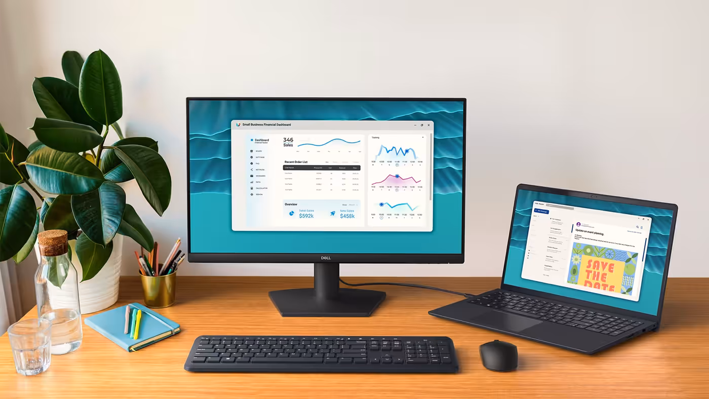 Front facing view of the Dell 24 Monitor on a desk with a laptop connected through an HDMI cord.