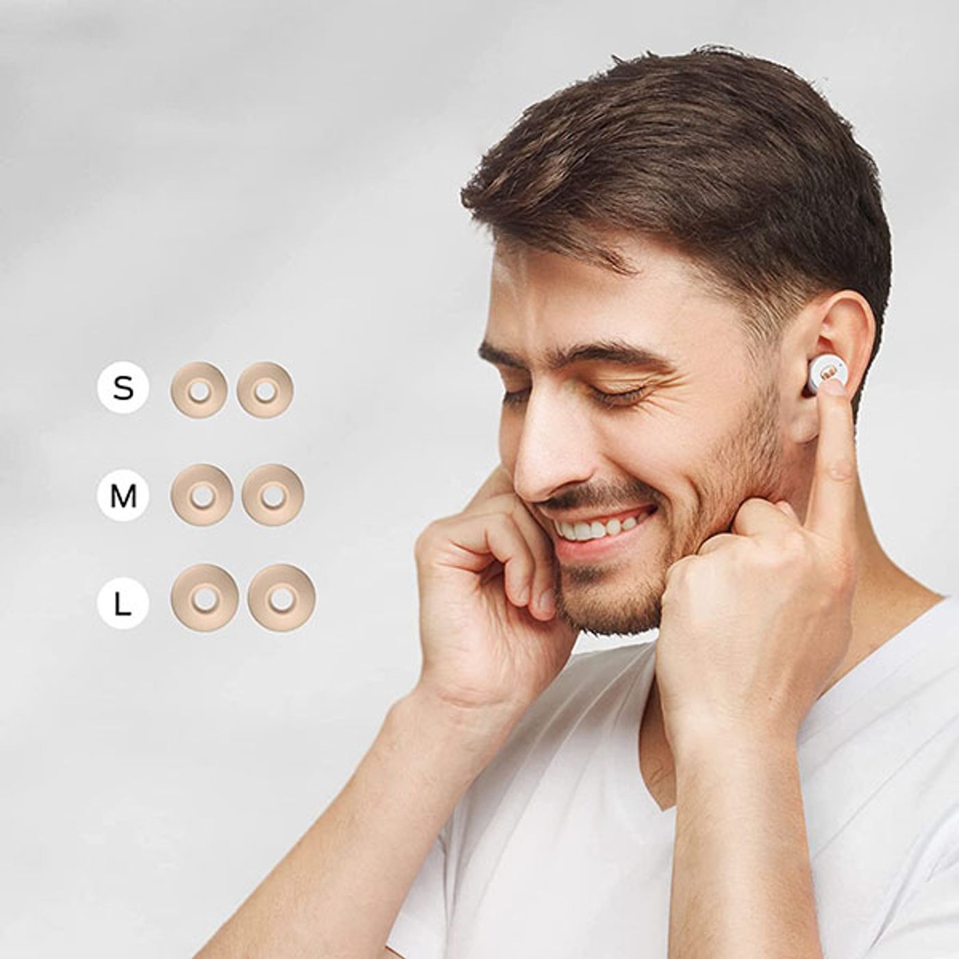 Truly wireless earbuds displayed with their charging case and bundled accessories