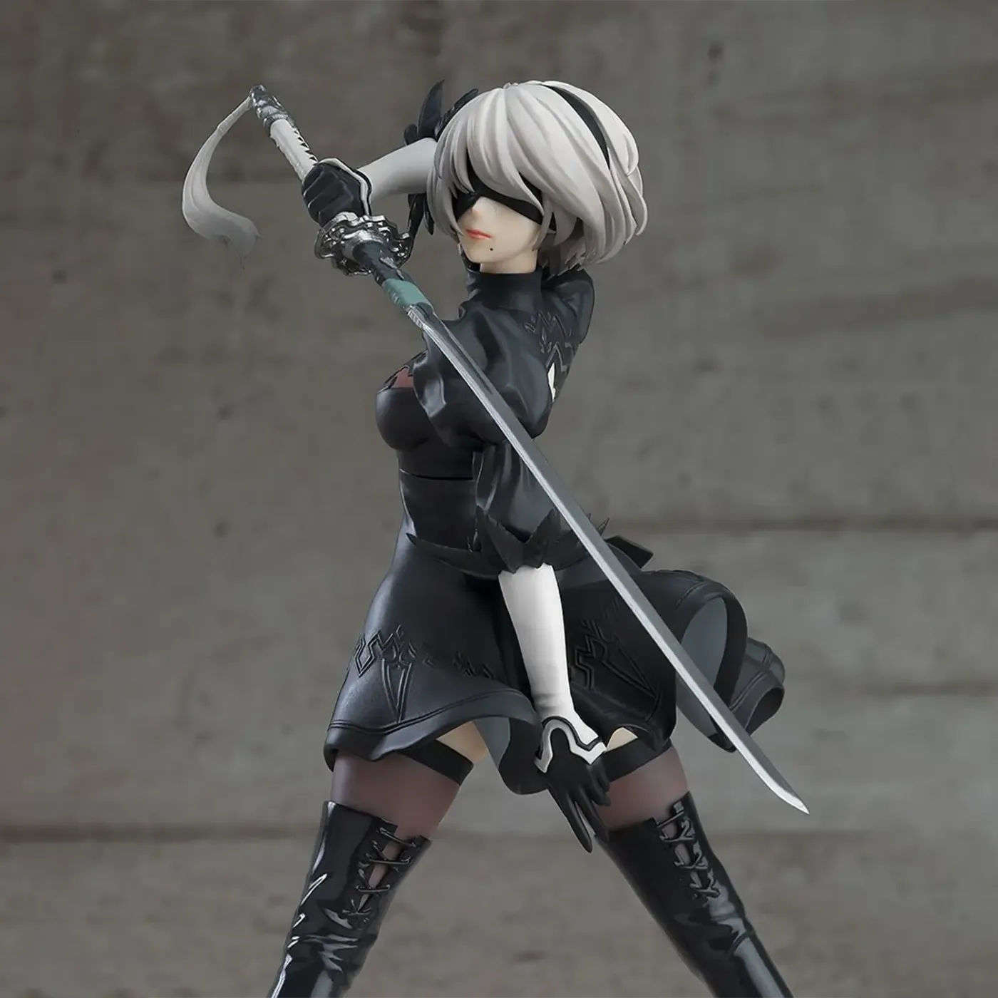 Close-up of the 2B figure showing her visor and the detailing on her black dress