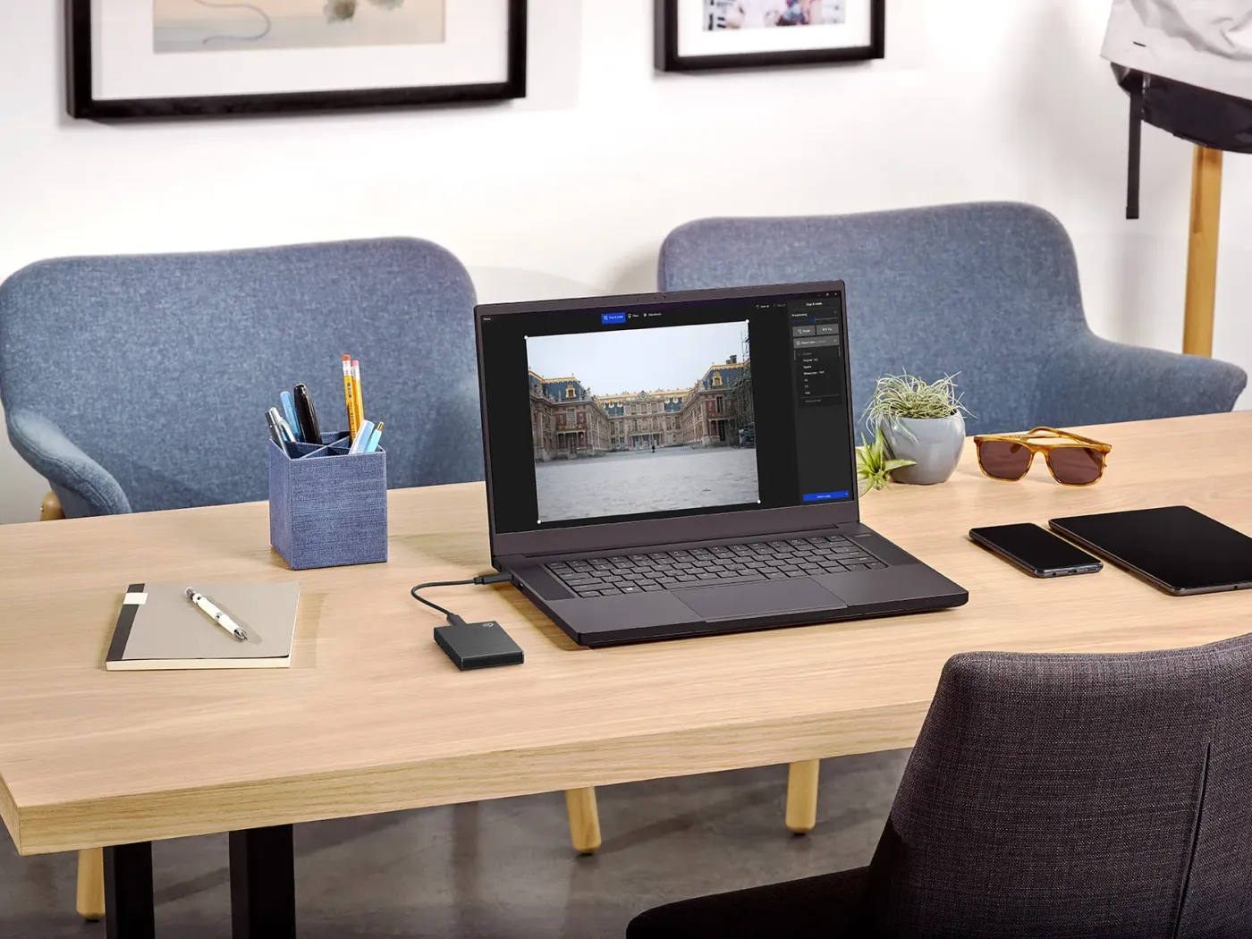 Portable Seagate SSD connected to a laptop on a workspace desk