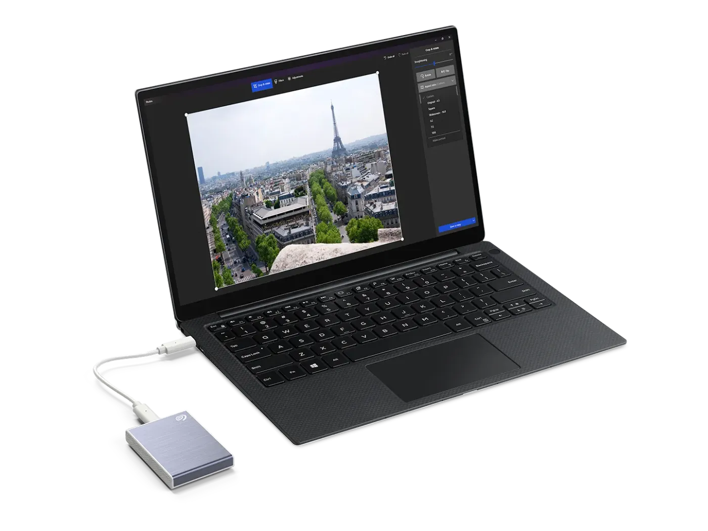 Laptop connected to a silver Seagate portable SSD using USB-C