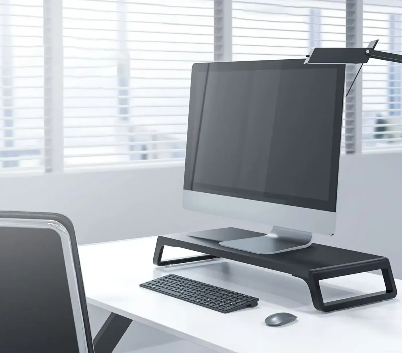 After using a monitor riser, showing upright posture and aligned eye level