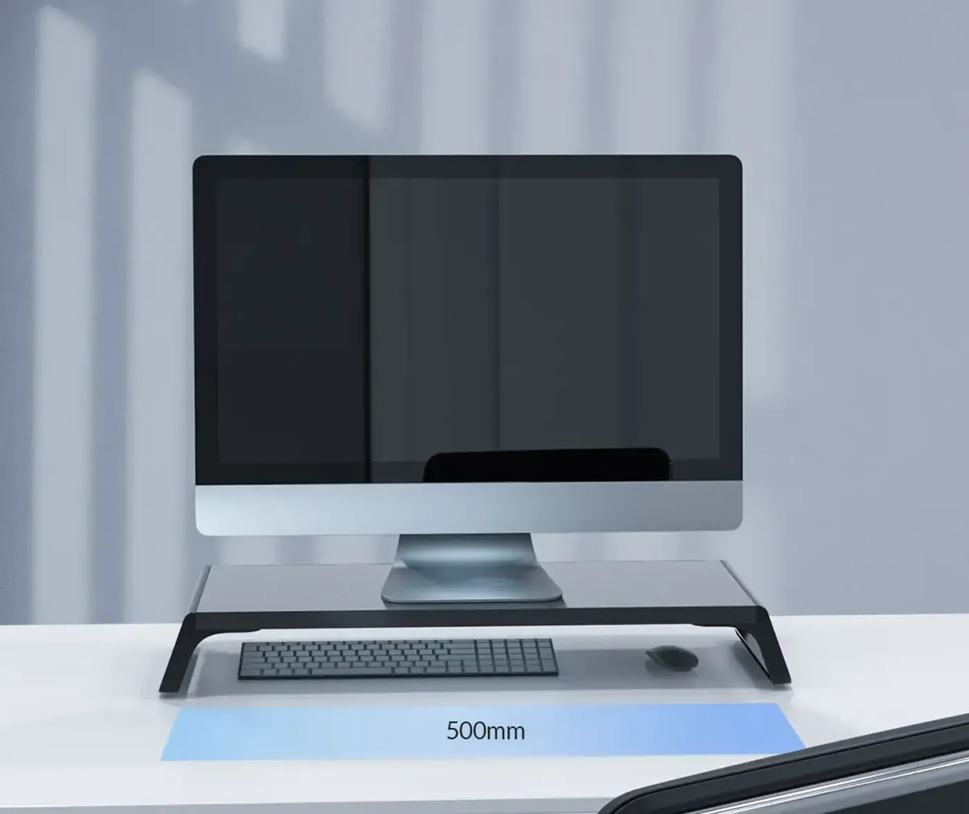 Orico black wooden monitor riser lifting a screen by roughly 7.5 cm