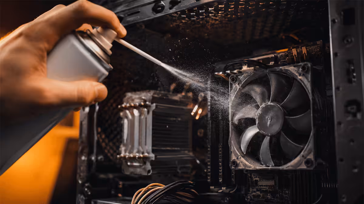 Cleaning dust from a PC fan with compressed air