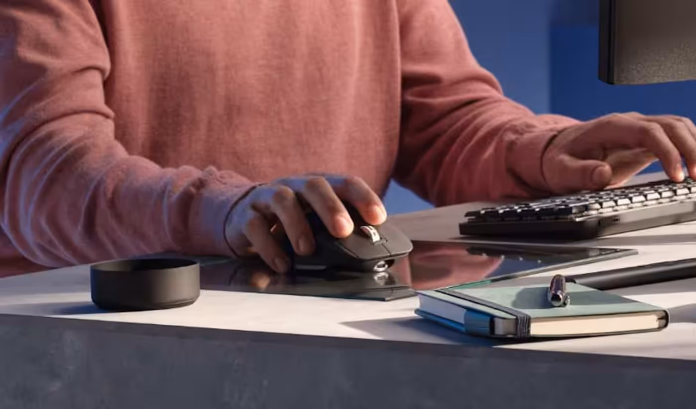 Person utilizing the MX Master 3S mouse on a glass surface demonstrating 8k DPI tracking