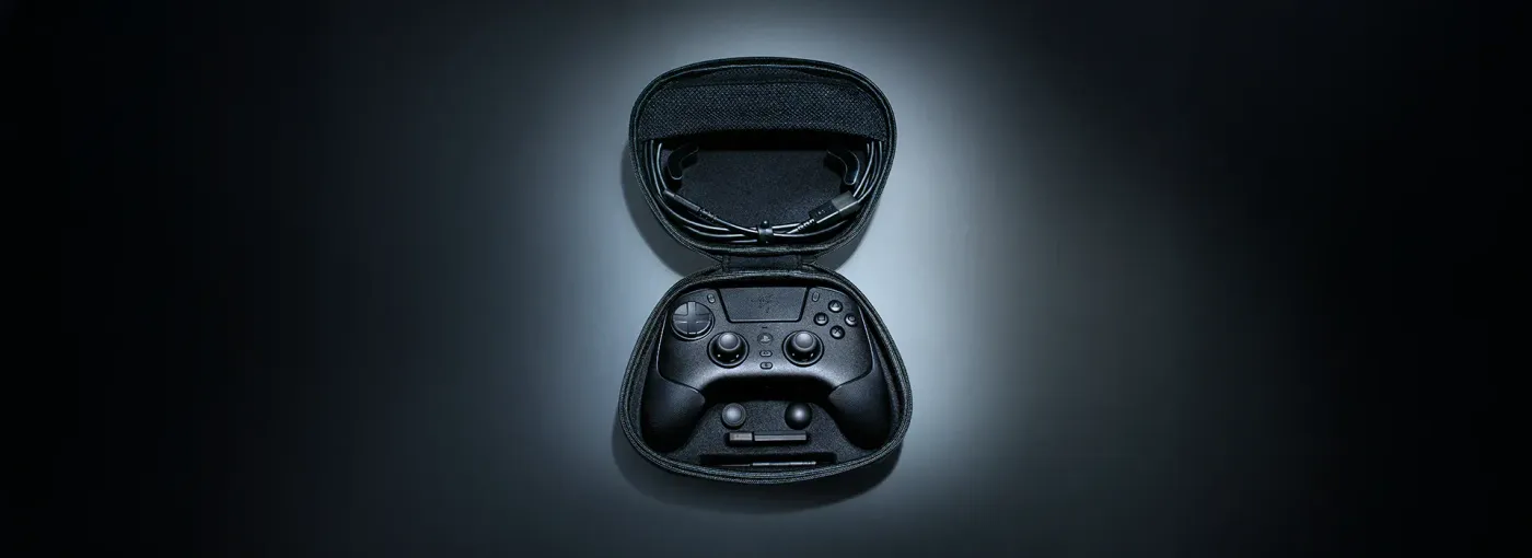 Open carrying case containing gaming controller with organized accessories and braided cable