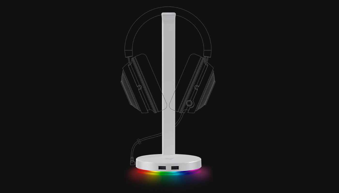 Razer Base Station V2 Chroma in Quartz pink holding a gaming headset on a desk