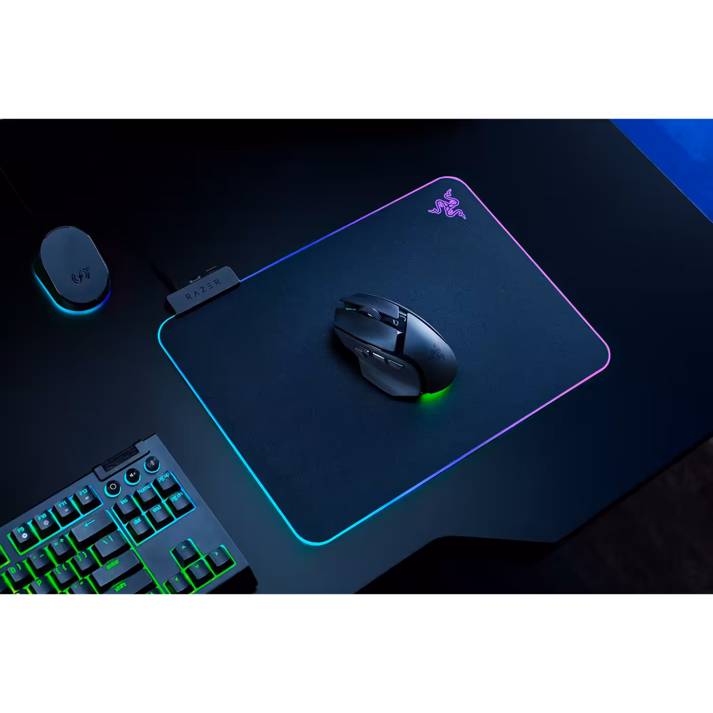 Top view of the black Razer Basilisk V4 HyperSpeed on a lit mouse mat beside a keyboard