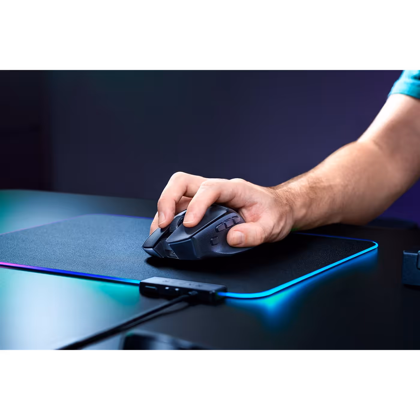 Hand resting on the black Razer Basilisk V4 HyperSpeed on a lit mouse mat