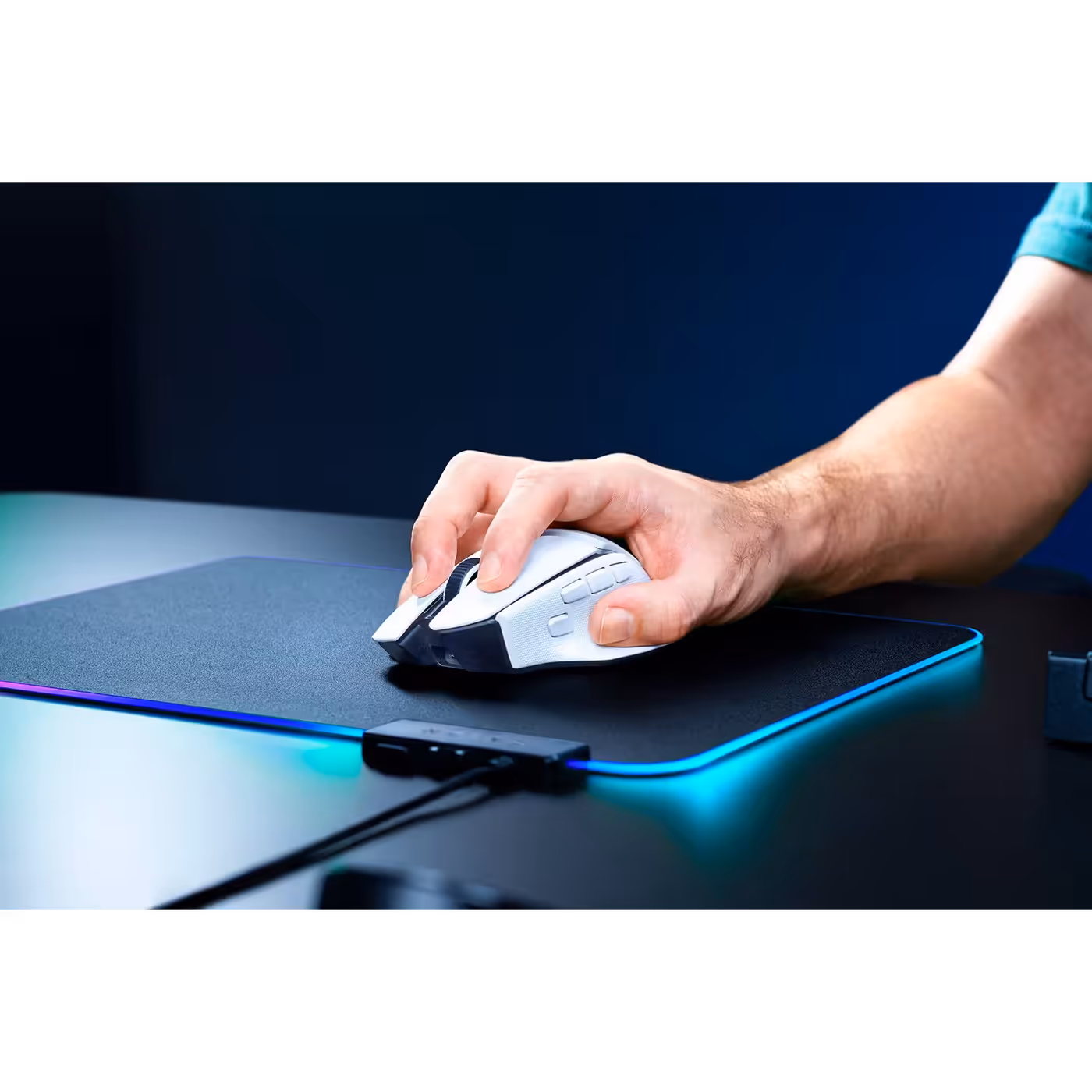 Hand resting on the white Razer Basilisk V4 HyperSpeed on a lit mouse mat