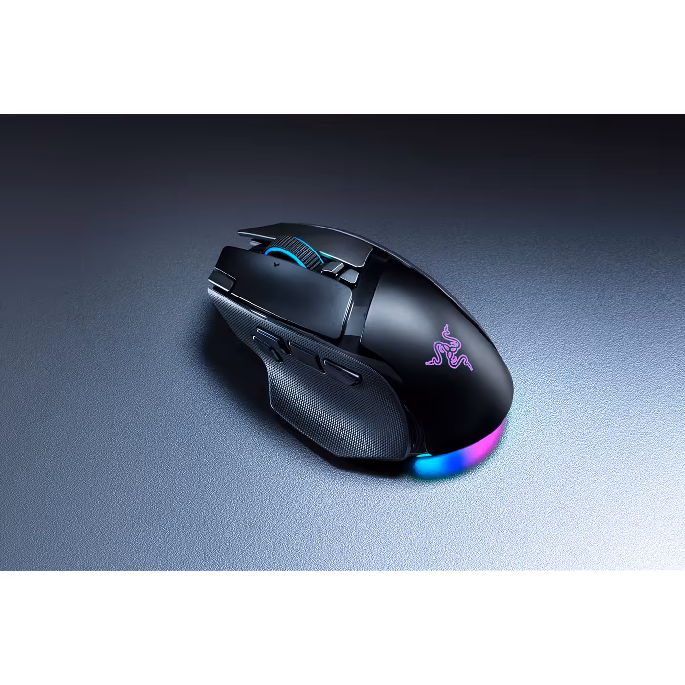 Razer Basilisk V4 Pro in black on a grey surface with Chroma underglow lit