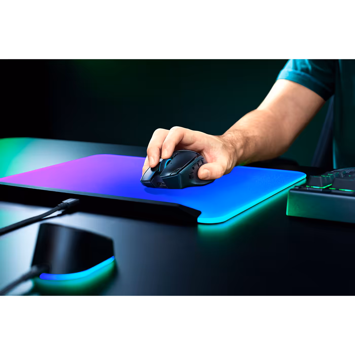 Hand resting on the Razer Basilisk V4 Pro on a lit mouse mat