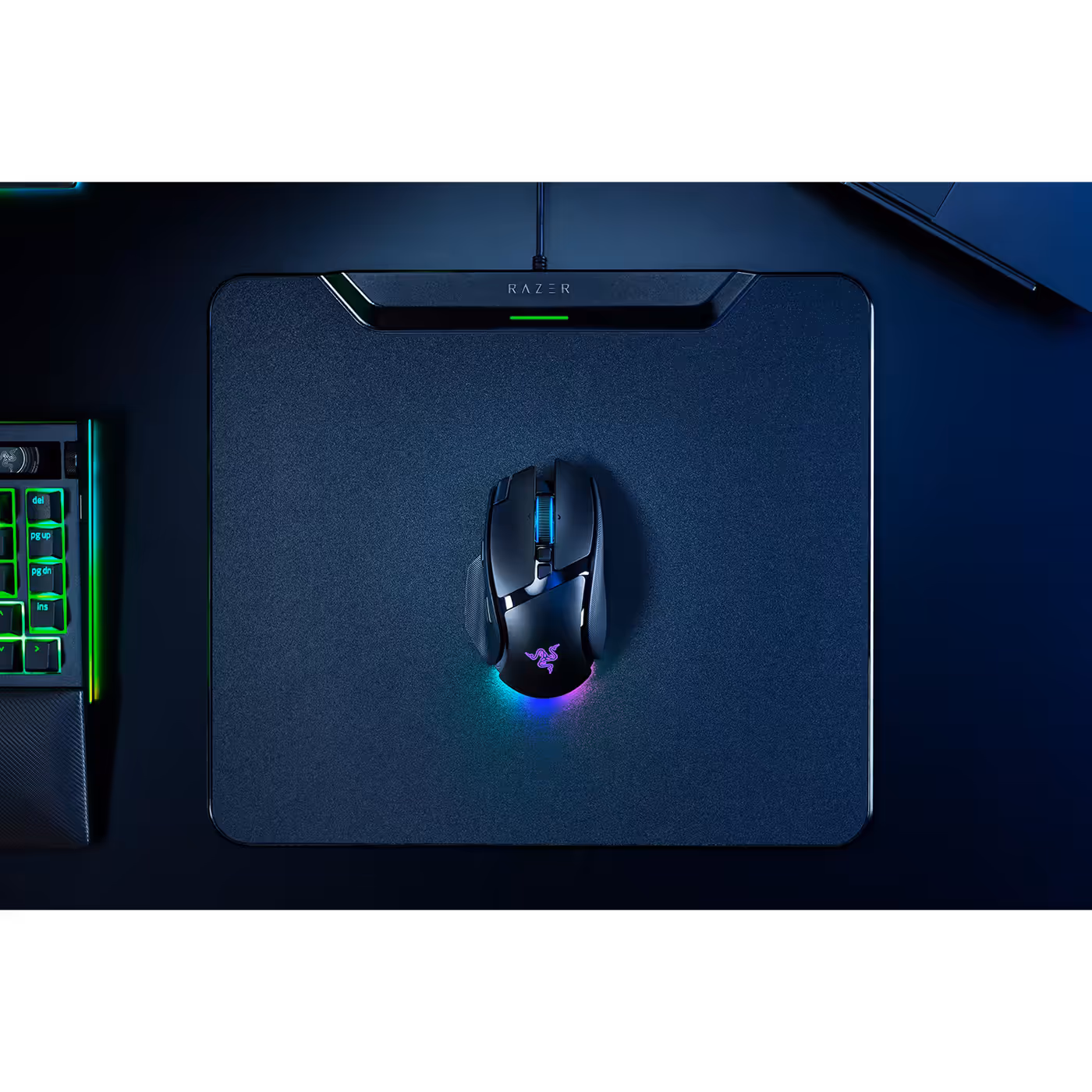 Top view of the Razer Basilisk V4 Pro on a mouse mat beside a keyboard