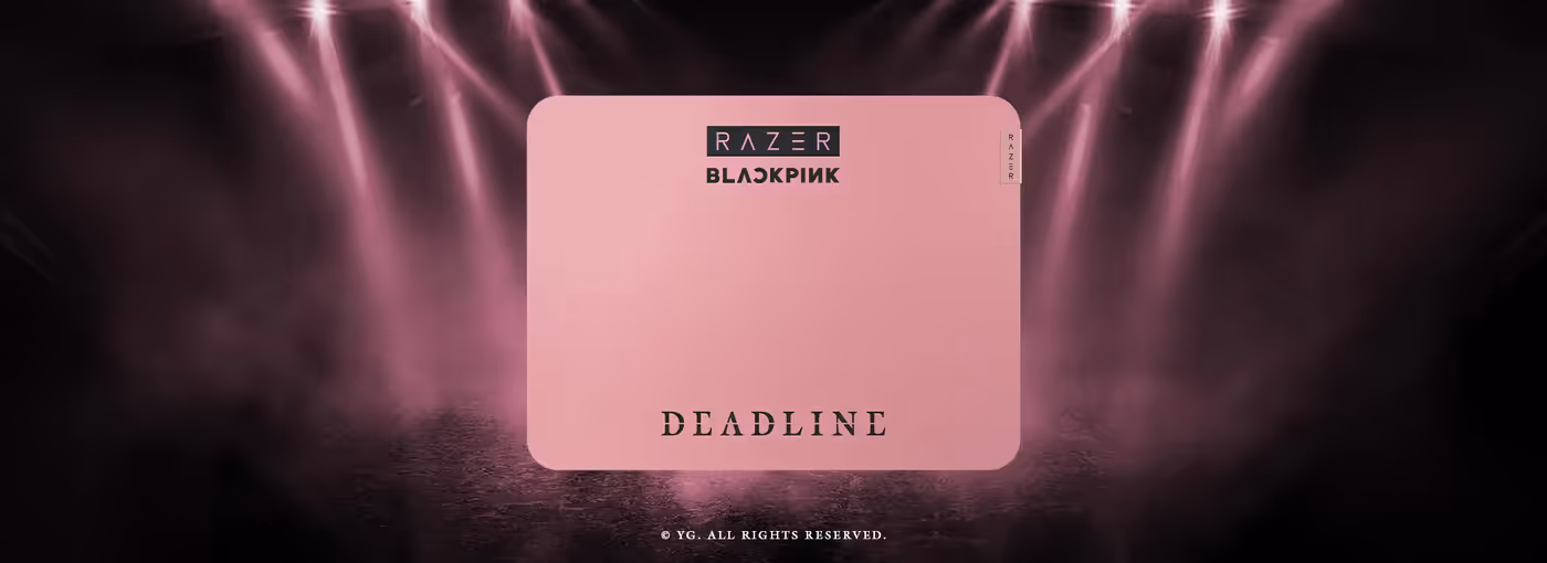 Pink rectangular mouse mat displayed against a smoky pink stage backdrop with overhead spotlights.