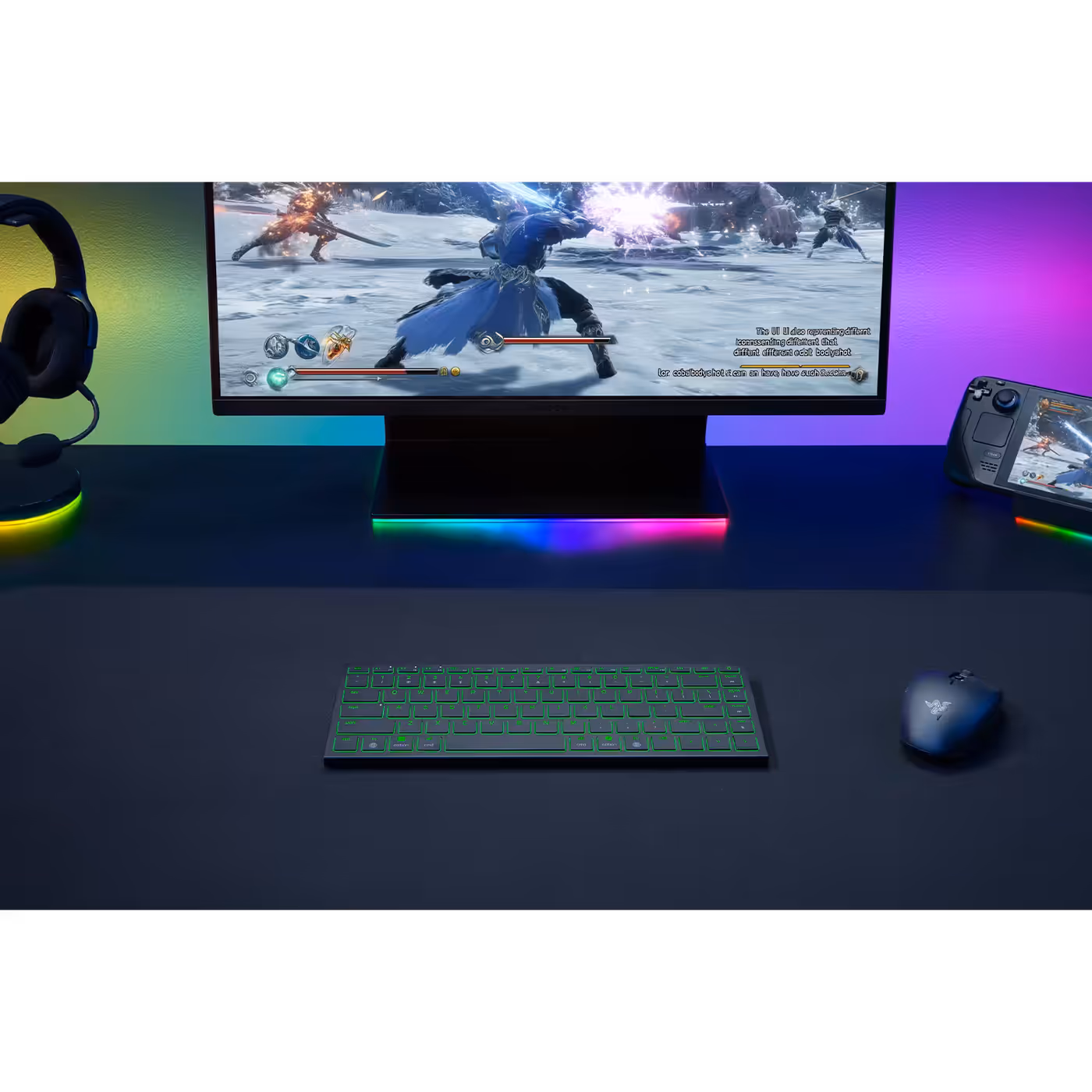 Razer Joro keyboard lit green on a desk below a gaming monitor