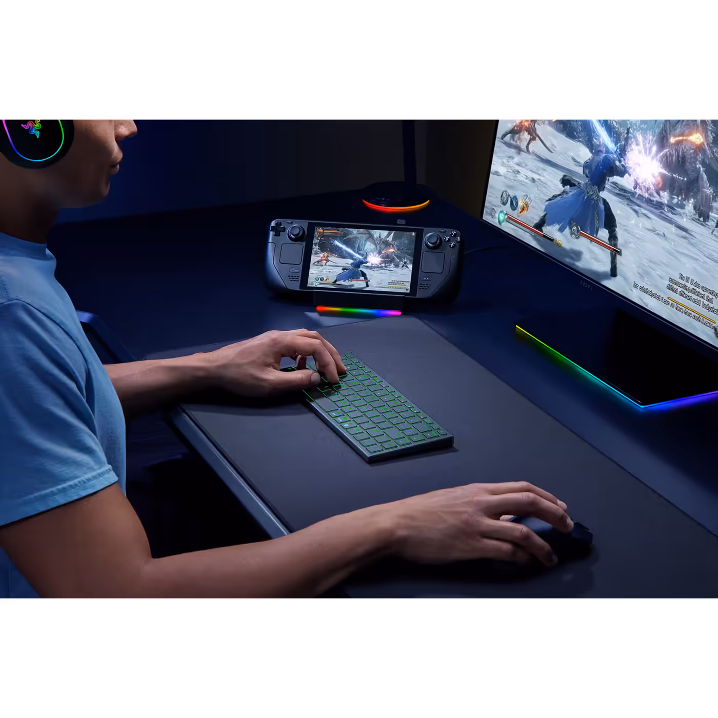 Person typing on the Razer Joro next to a Steam Deck and monitor